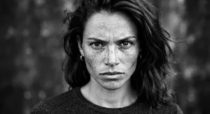 A black and white close-up portrait of a freckled woman with an intense gaze. - Google Nano Banana 2 Lite