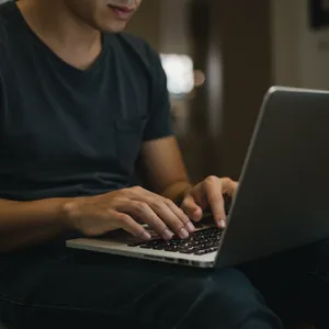 A person typing on a laptop keyboard, showing both hands on the keys. - Google Imagen 3.0