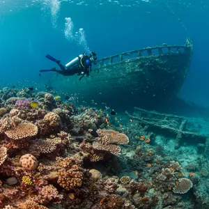 An underwater scene with scuba divers exploring a coral reef alongside colorful fish and a sunken ship. - Google Imagen 3.0