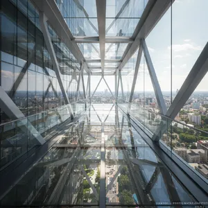 Photorealistic rendering of a contemporary glass skybridge between two skyscrapers, seen from inside with city views visible through glass walls and floor. Show accurate reflections and structural details. - Google Imagen 3.0