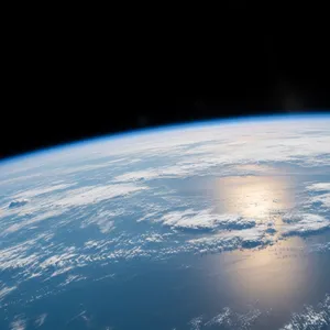 Photorealistic aerial photograph clearly showing the edge of the Earth from space, capturing realistic curvature, atmosphere, and sunlight reflections - Google Imagen 4.0 Ultra