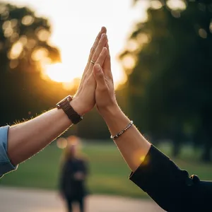 Two people high-fiving, with focus on their hands meeting mid-air. - Google Imagen 4.0 Ultra