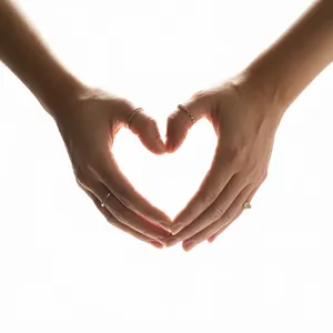 Two hands forming a heart shape together against a plain background. - Ideogram Ideogram 3.0 (Quality)