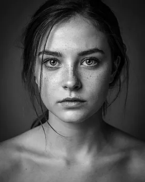 A black and white close-up portrait of a freckled woman with an intense gaze. - Ideogram Ideogram 4.0 (Quality)