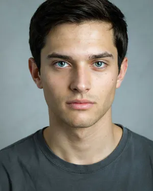 A studio headshot of a young man with one blue eye and one green eye (heterochromia). - Ideogram Ideogram 4.0 (Quality)