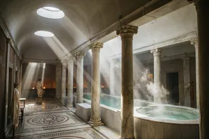 An ancient Roman bathhouse interior with accurate architectural details - marble columns, mosaic floors, arched ceilings, and steam rising from pools. Natural light from oculus openings. - Ideogram Ideogram 4.0 (Quality)