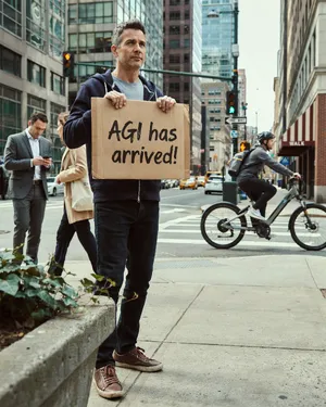 Photorealistic daytime street photograph, clearly showing a man standing still on a busy urban street corner holding a rectangular cardboard sign clearly facing camera, handwritten bold black marker text clearly readable as 