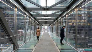 Photorealistic rendering of a contemporary glass skybridge between two skyscrapers, seen from inside with city views visible through glass walls and floor. Show accurate reflections and structural details. - Ideogram Ideogram 4.0 (Quality)
