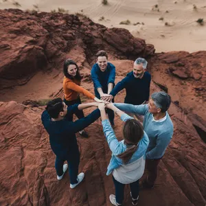 A group of five people joining hands in a circle, seen from above. - Ideogram Ideogram V2