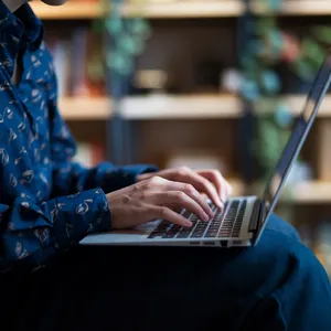 A person typing on a laptop keyboard, showing both hands on the keys. - Ideogram Ideogram V2