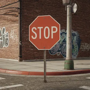 A red stop sign on a street corner displaying the word 