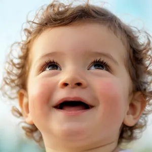 A hyper-realistic photo of a toddler with curly hair and big eyes, looking upward. - Krea Krea 2 Large