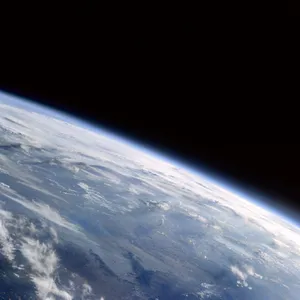 Photorealistic aerial photograph clearly showing the edge of the Earth from space, capturing realistic curvature, atmosphere, and sunlight reflections - Krea Krea 2 Large