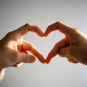 Two hands forming a heart shape together against a plain background. - Krea Krea 2 Large