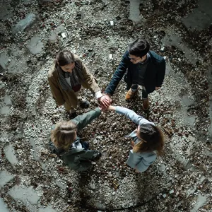 A group of five people joining hands in a circle, seen from above. - Midjourney Midjourney v7
