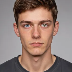 A studio headshot of a young man with one blue eye and one green eye (heterochromia). - Black Forest Labs FLUX 3 Image
