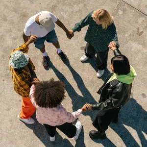 A group of five people joining hands in a circle, seen from above. - Recraft Recraft V4.1