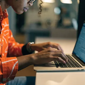 A person typing on a laptop keyboard, showing both hands on the keys. - Recraft Recraft V4.1