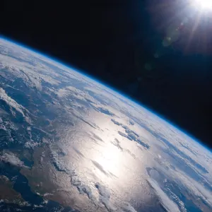 Photorealistic aerial photograph clearly showing the edge of the Earth from space, capturing realistic curvature, atmosphere, and sunlight reflections - Recraft Recraft V4.1