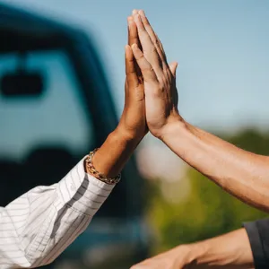 Two people high-fiving, with focus on their hands meeting mid-air. - Recraft Recraft V4.1