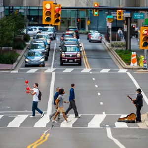 A busy city intersection with cars, pedestrians, and street performers all in one frame. - Reve Reve Image (Halfmoon)