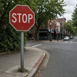 A red stop sign on a street corner displaying the word 