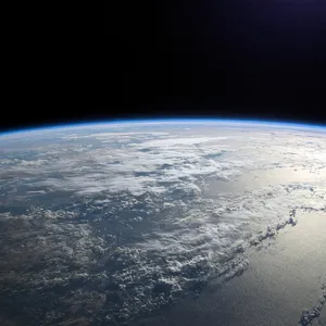 Photorealistic aerial photograph clearly showing the edge of the Earth from space, capturing realistic curvature, atmosphere, and sunlight reflections - XAI Grok Imagine 2.0