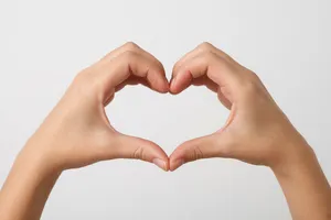 Two hands forming a heart shape together against a plain background. - XAI Grok Imagine 2.0 (Preview)
