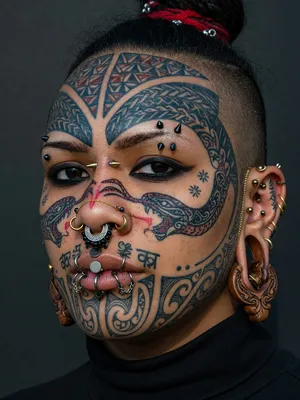A portrait of a person with elaborate facial tattoos and piercings, shown in sharp detail. - XAI Grok Imagine (Quality)