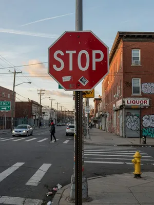 A red stop sign on a street corner displaying the word 