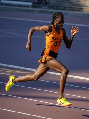 A runner mid-stride in a full-body action shot, limbs in motion and well-defined. - XAI Grok Imagine (Quality)