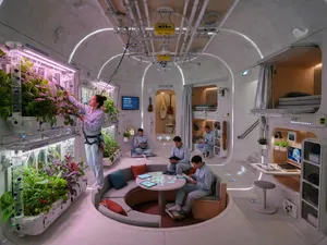 Interior of a futuristic space habitat with hydroponics gardens, communal areas, and living quarters. Show curved walls, artificial gravity considerations, and multipurpose furniture designs. - XAI Grok Imagine (Quality)