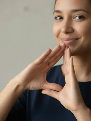 Photorealistic close-up portrait of a person clearly performing the American Sign Language gesture for 