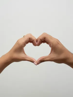 Two hands forming a heart shape together against a plain background. - XAI Grok Imagine (Quality)