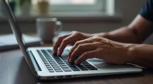 A person typing on a laptop keyboard, showing both hands on the keys. - XAI Grok Imagine