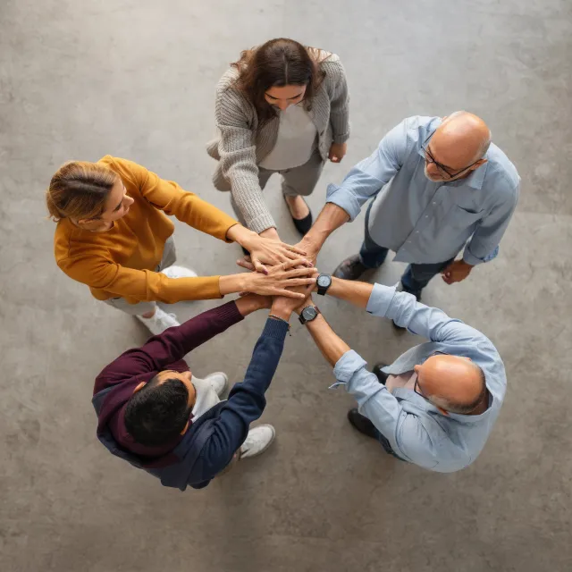 A group of five people joining hands in a circle, seen from above - Black Forest Labs FLUX.2 Max