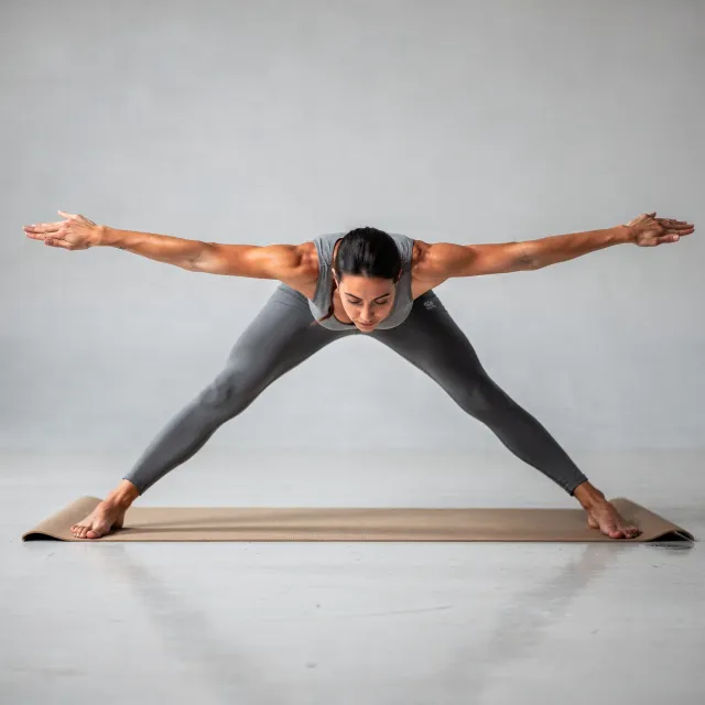A yoga practitioner in a complex pose, arms and legs fully extended (full-body view) - Black Forest Labs FLUX.2 Max