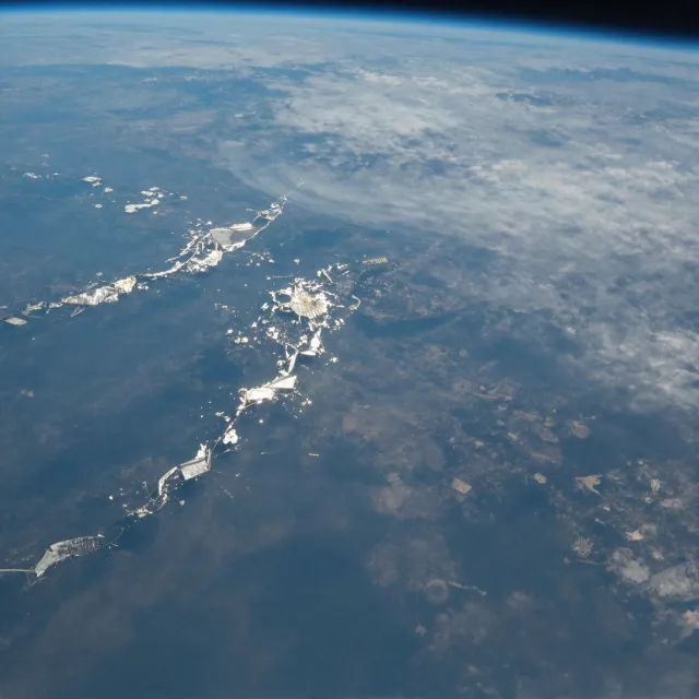 Photorealistic aerial photograph clearly showing the edge of the Earth from space, capturing realistic curvature, atmosphere, and sunlight reflections - Z-Image Turbo