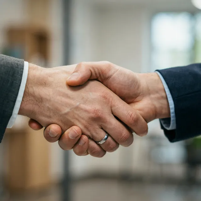 A close-up of two people shaking hands, both hands fully visible with five fingers each… - Ideogram 4.0 (Quality)