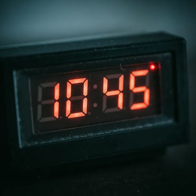 A digital clock display showing the time "10:45" in LED-style numerals, photorealistic… - Ideogram 4.0 (Quality)