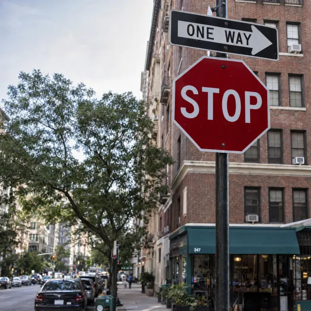A red stop sign on a street corner displaying the word "STOP", photorealistic urban… - OpenAI GPT Image 2.5 Sunburst