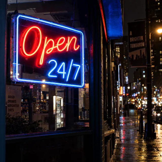A storefront sign that says "Open 24/7" in neon lights, nighttime urban photography. - GPT Image 2.5 Sunburst