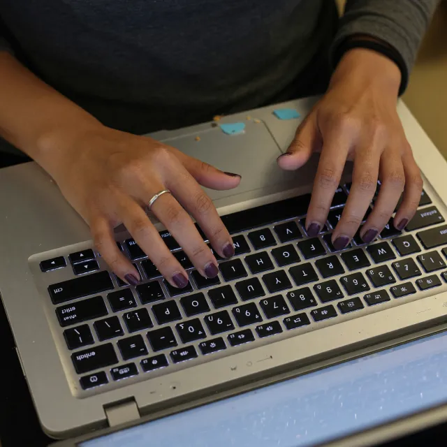 A person typing on a laptop keyboard, showing both hands on the keys - XAI Grok Imagine (Quality)