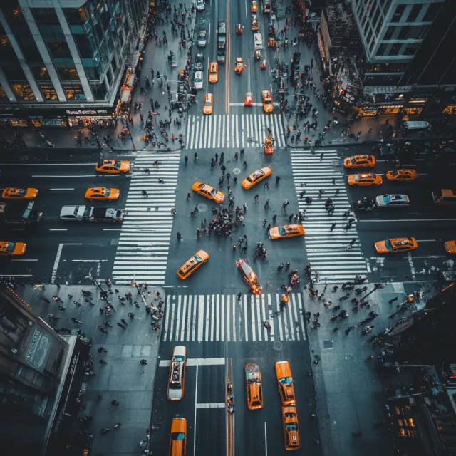 A busy city intersection with cars, pedestrians, and street performers all in one frame - Midjourney V6.1
