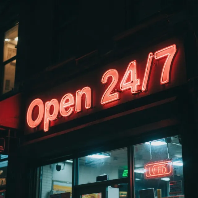 A storefront sign that says "Open 24/7" in neon lights, nighttime urban photography. - Seedream 3.0
