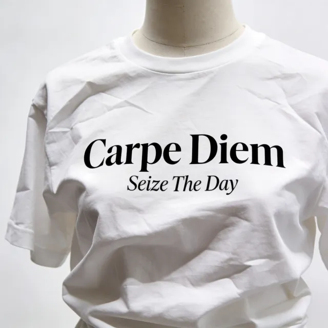 A wrinkled white T-shirt with "Carpe Diem" in bold serif font and "Seize The Day" in… - Bytedance Seedream 4.5