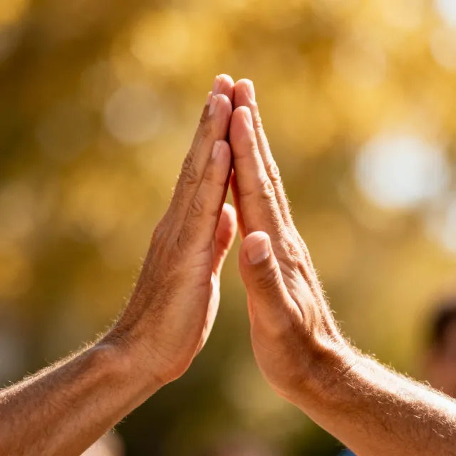 Two people high-fiving, with focus on their hands meeting mid-air - Bytedance Seedream 4.0