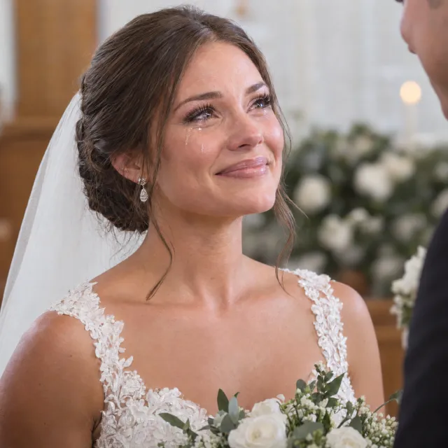A bride on her wedding day, smiling with tears of joy in her eyes. - Takumi 1.1