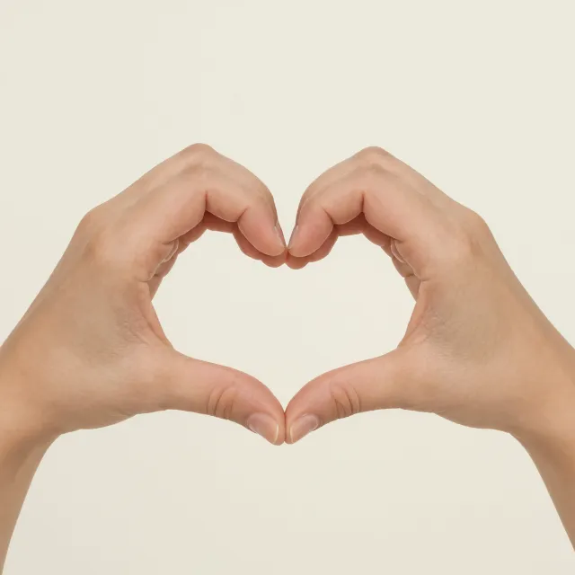 Two hands forming a heart shape together against a plain background. - Reve 2.1