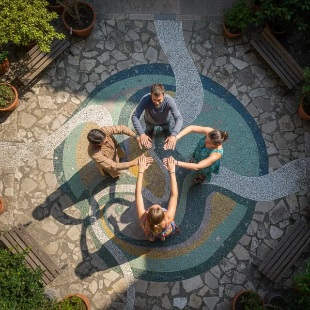 A group of five people joining hands in a circle, seen from above - Google Nano Banana (2.5 Flash)